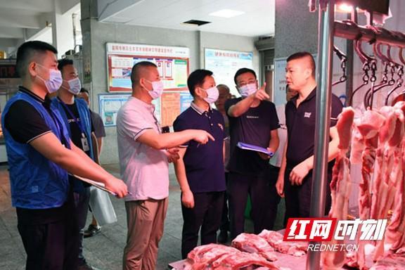 执法人员正在抽检经营户销售的鲜肉及肉类制品.